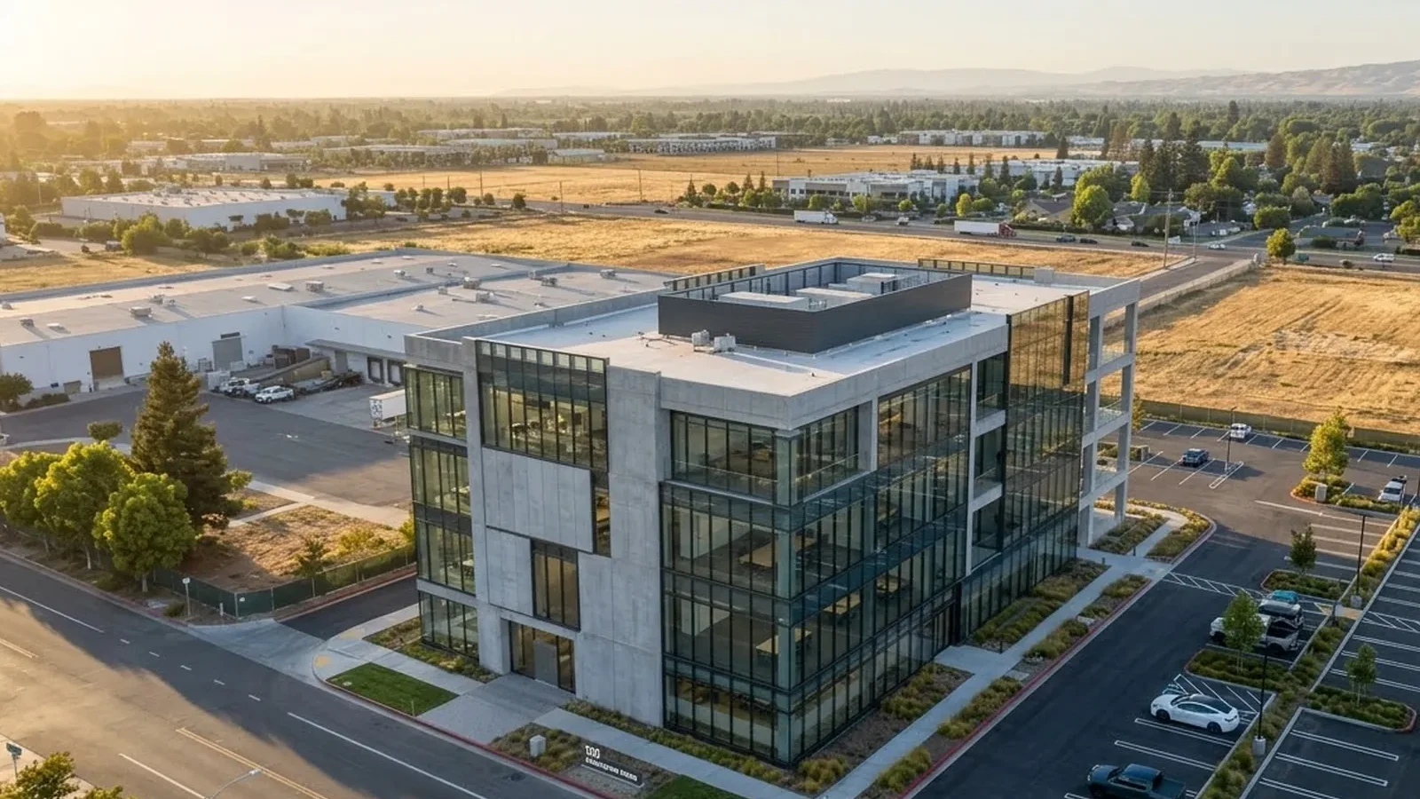 Aerial view of a commercial building beside open land
